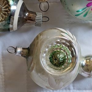 Four antique Christmas tree ornaments.